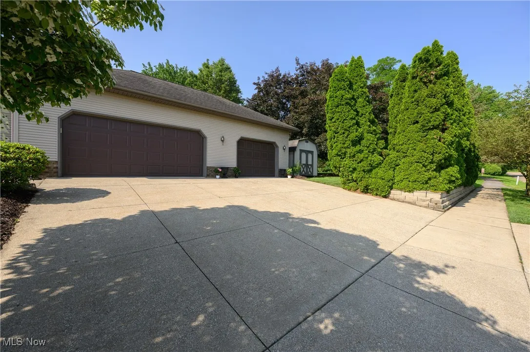 View of side of home featuring an outbuilding and a garage
