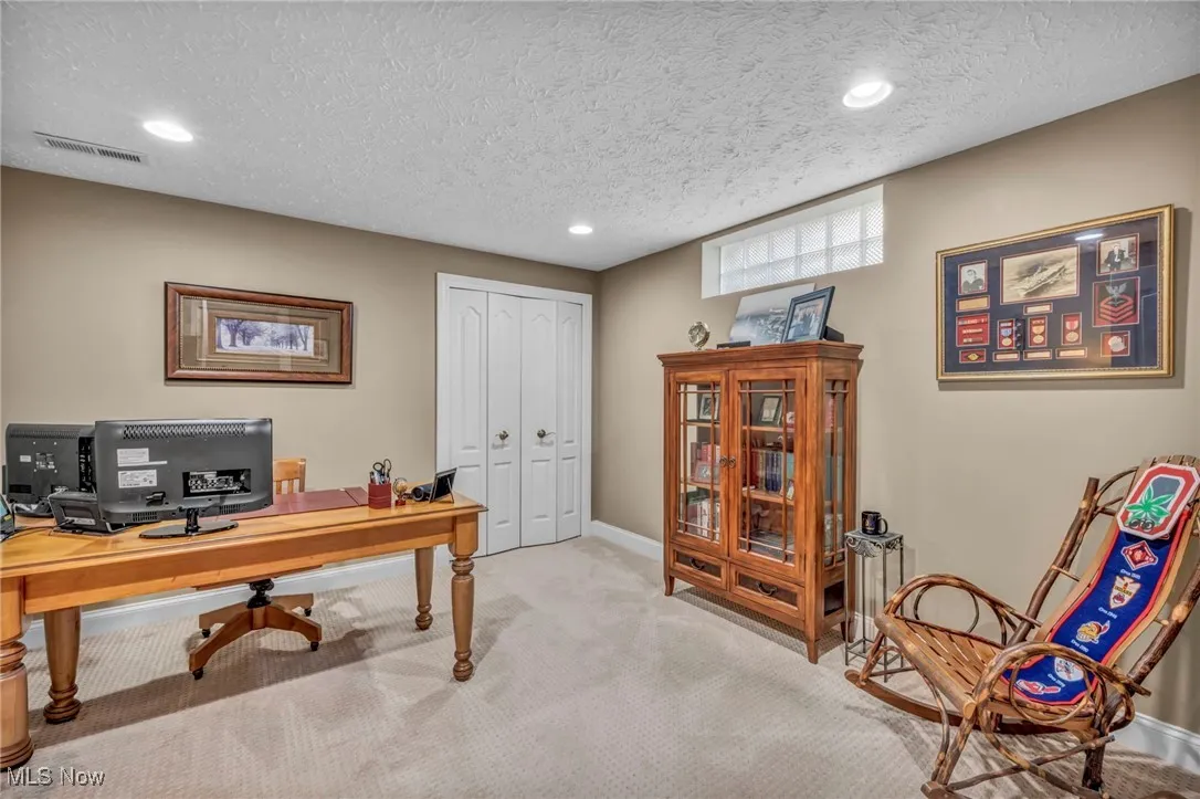 Home office with carpet flooring, a textured ceiling, and recessed lighting. Could also be another bedroom