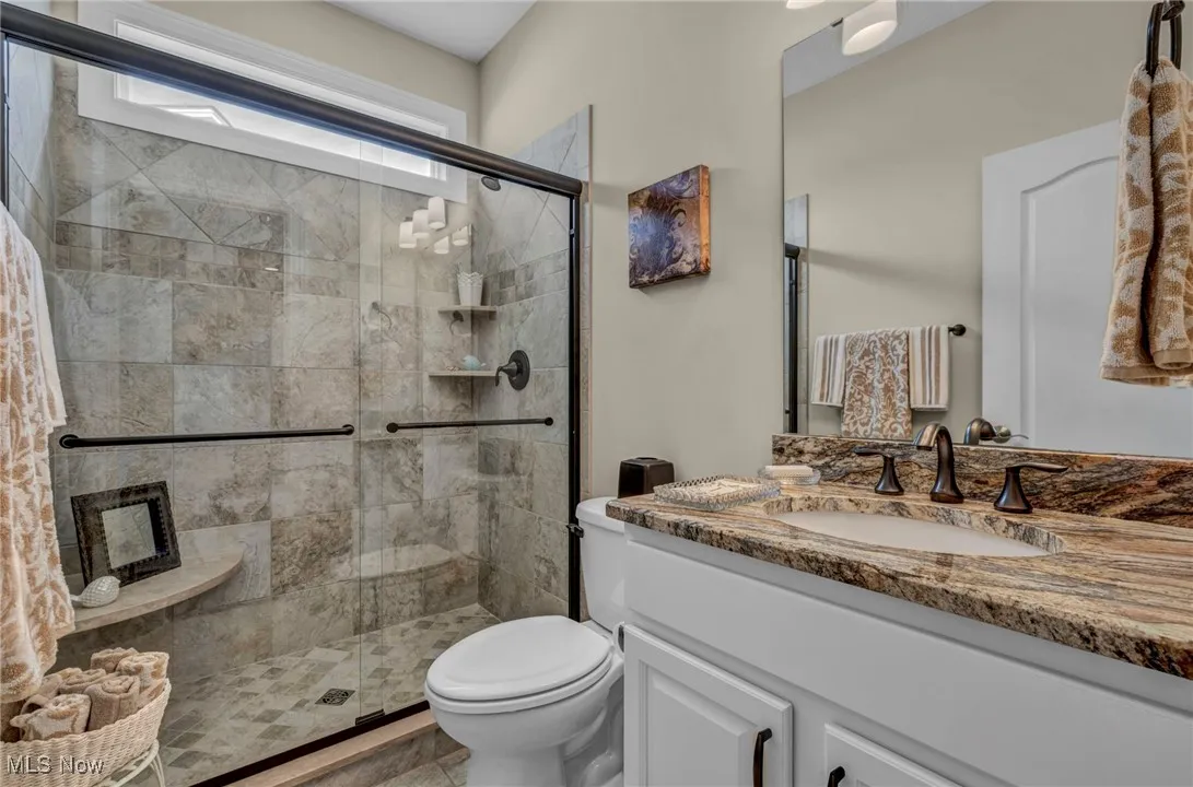 Full bath with vanity and a shower stall