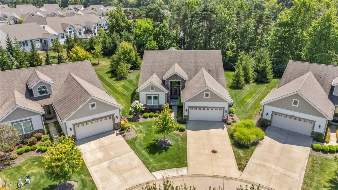 Aerial perspective of suburban area with a tree filled landscape