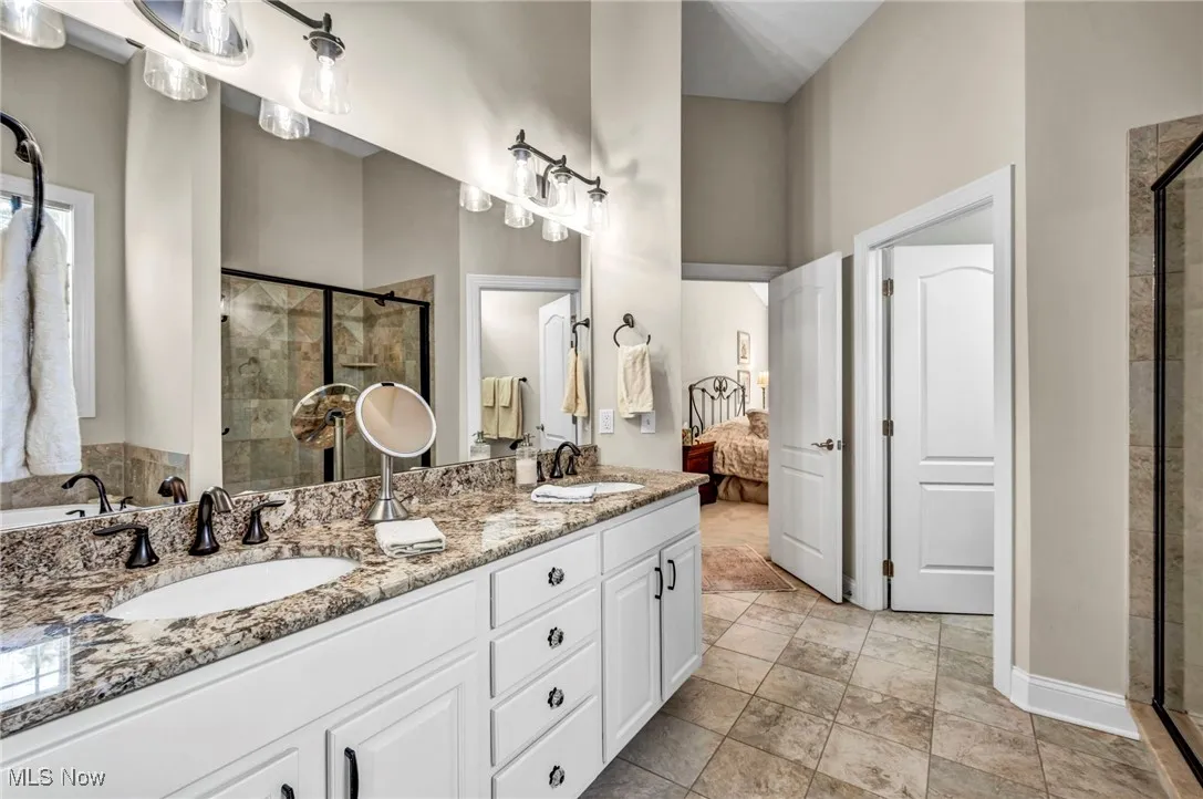 Ensuite bathroom with a shower stall and double vanity