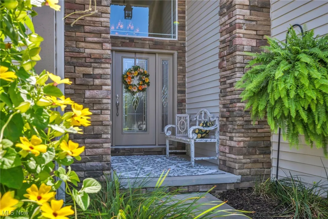 Doorway to property featuring a deck and stone siding