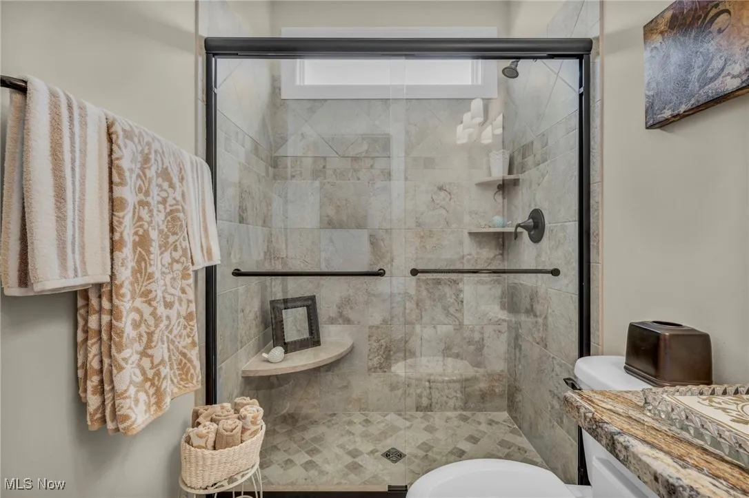 Bathroom featuring a shower stall and vanity