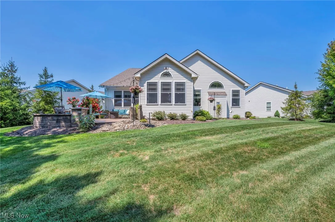 View of back of property featuring a Back yard and a patio