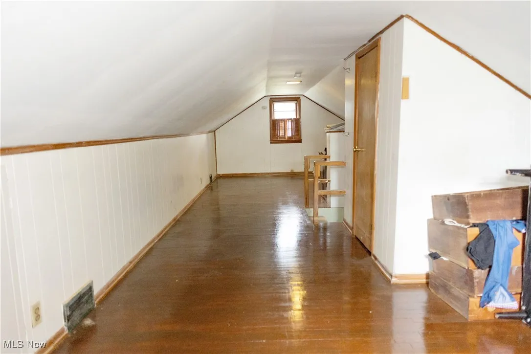 Bonus room featuring wood-type flooring and lofted ceiling