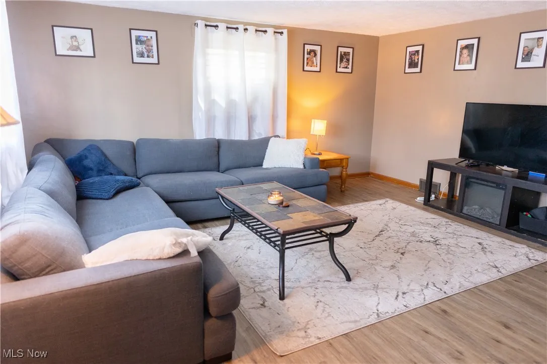 Living room featuring wood finished floors and a textured ceiling