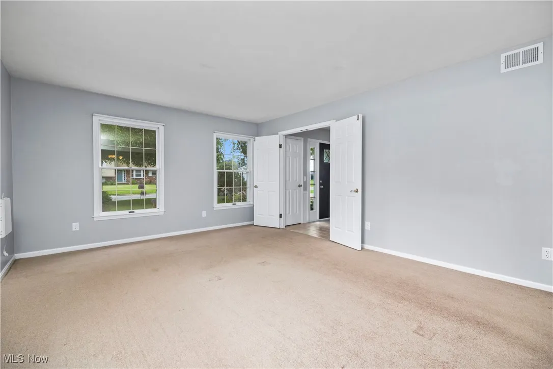 Unfurnished bedroom with carpet flooring and baseboards