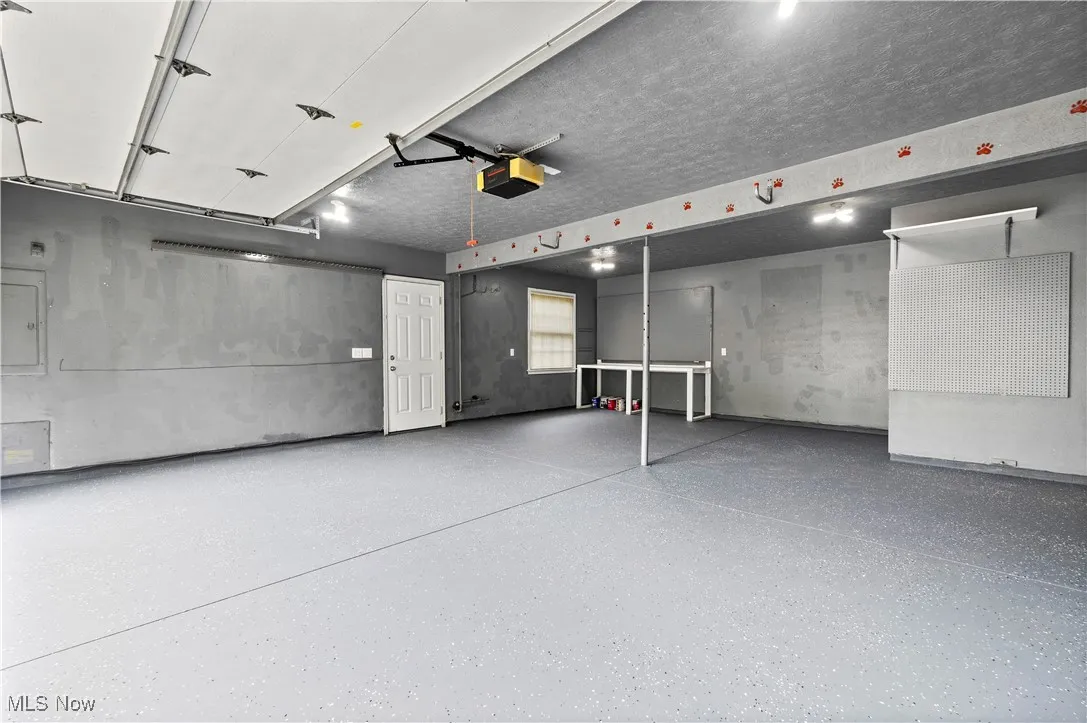 Garage featuring a garage door opener