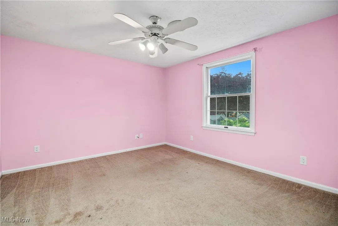 Unfurnished room with carpet floors and ceiling fan