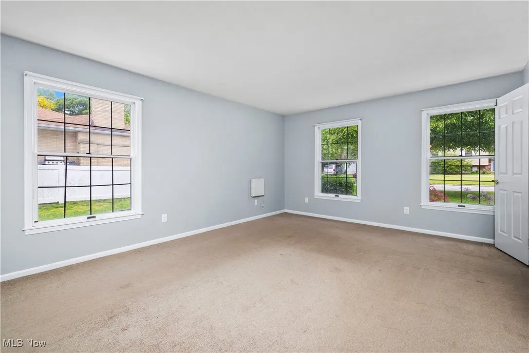 Carpeted empty room with baseboards
