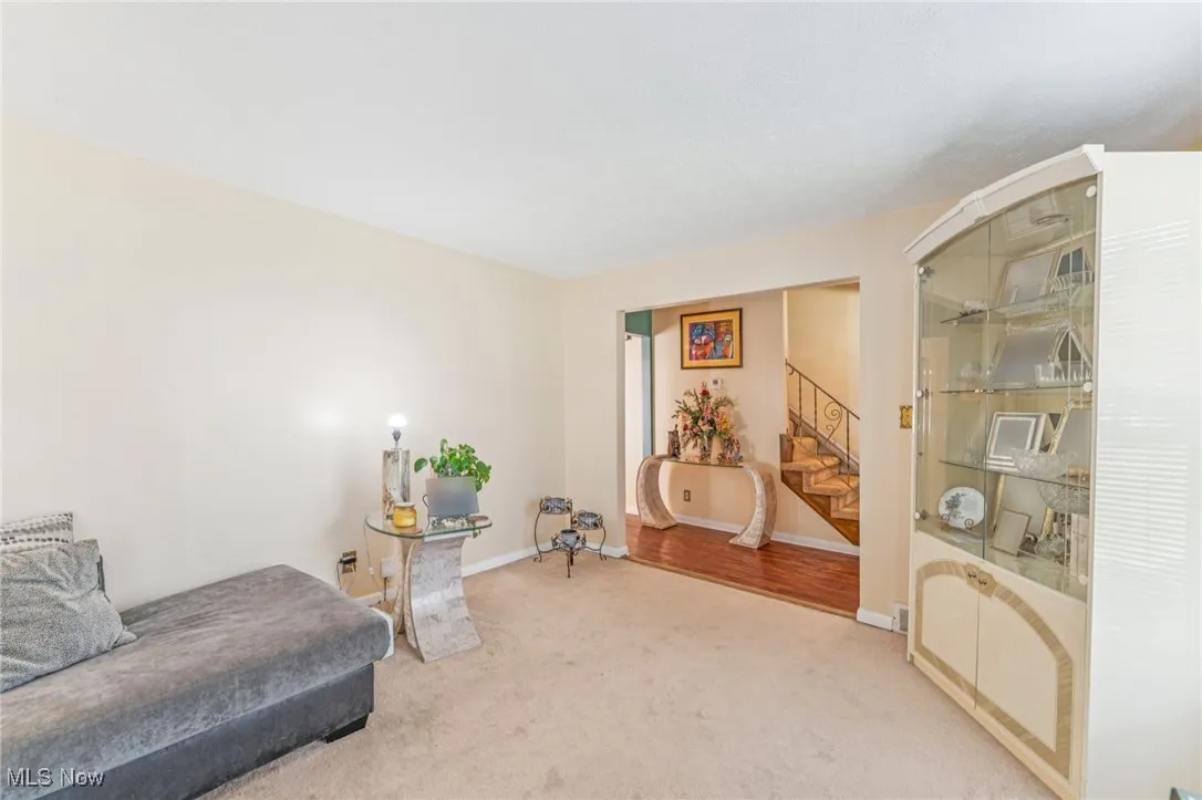 Living area featuring carpet floors and stairs