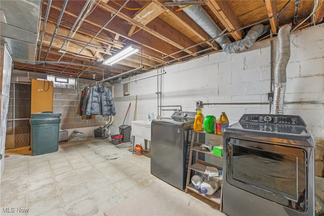 Below grade area with tile patterned floors and washing machine and dryer