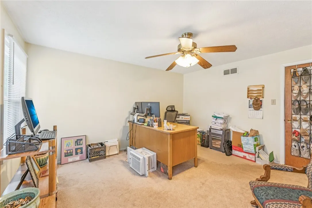 Office space with carpet and ceiling fan