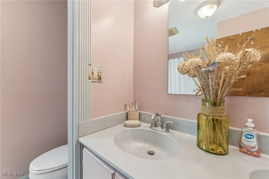Full bath featuring double vanity and toilet