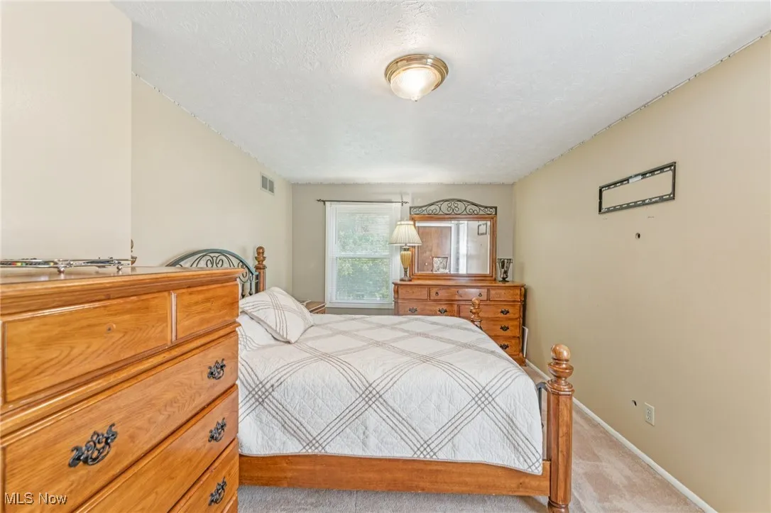 Bedroom with carpet floors and a textured ceiling