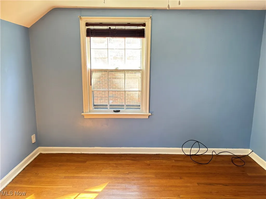 Empty room with baseboards and wood finished floors