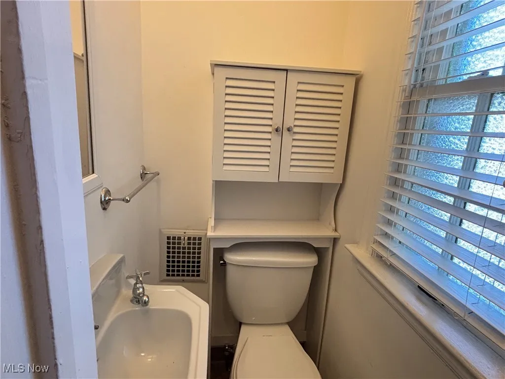 Half bathroom featuring toilet and a sink