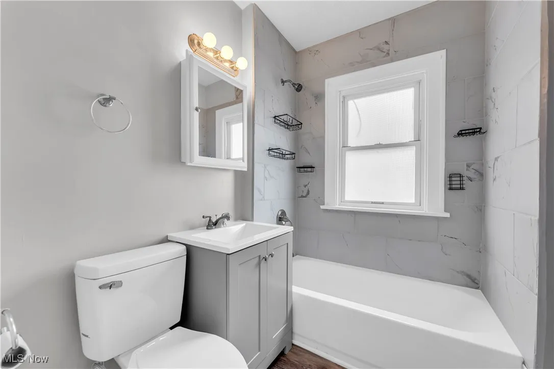 Full bathroom with bathing tub / shower combination and vanity