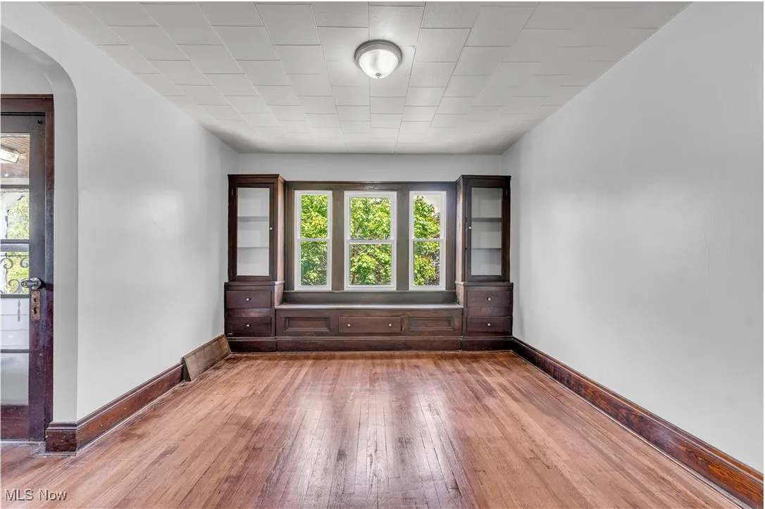 Spare room featuring hardwood / wood-style floors and arched walkways