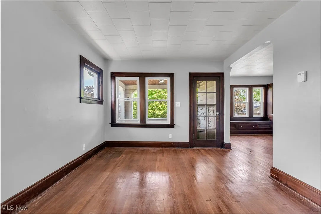 Spare room with hardwood / wood-style flooring and baseboards