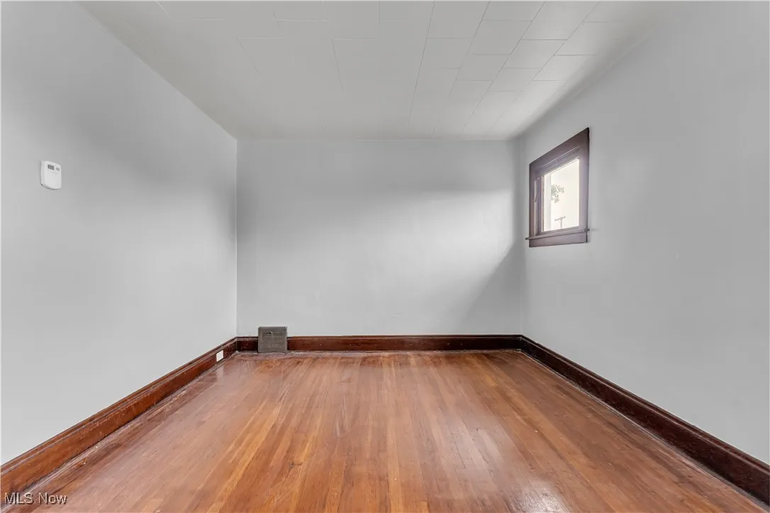 Empty room featuring wood-type flooring and baseboards
