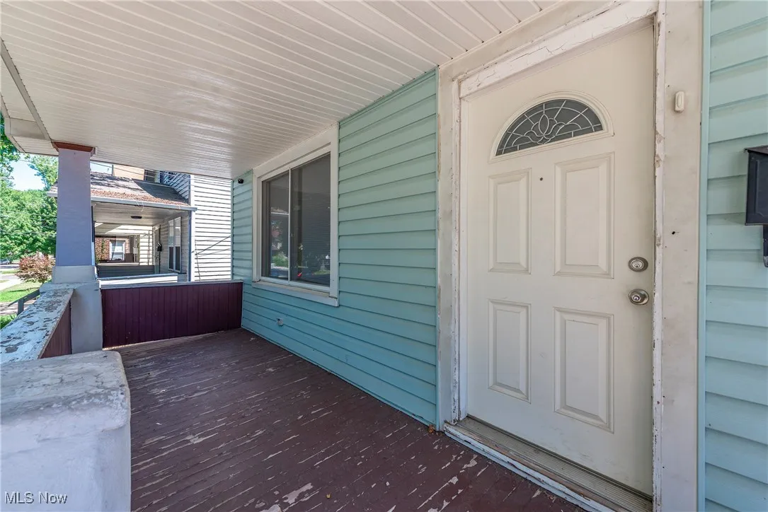 Doorway to property with covered porch