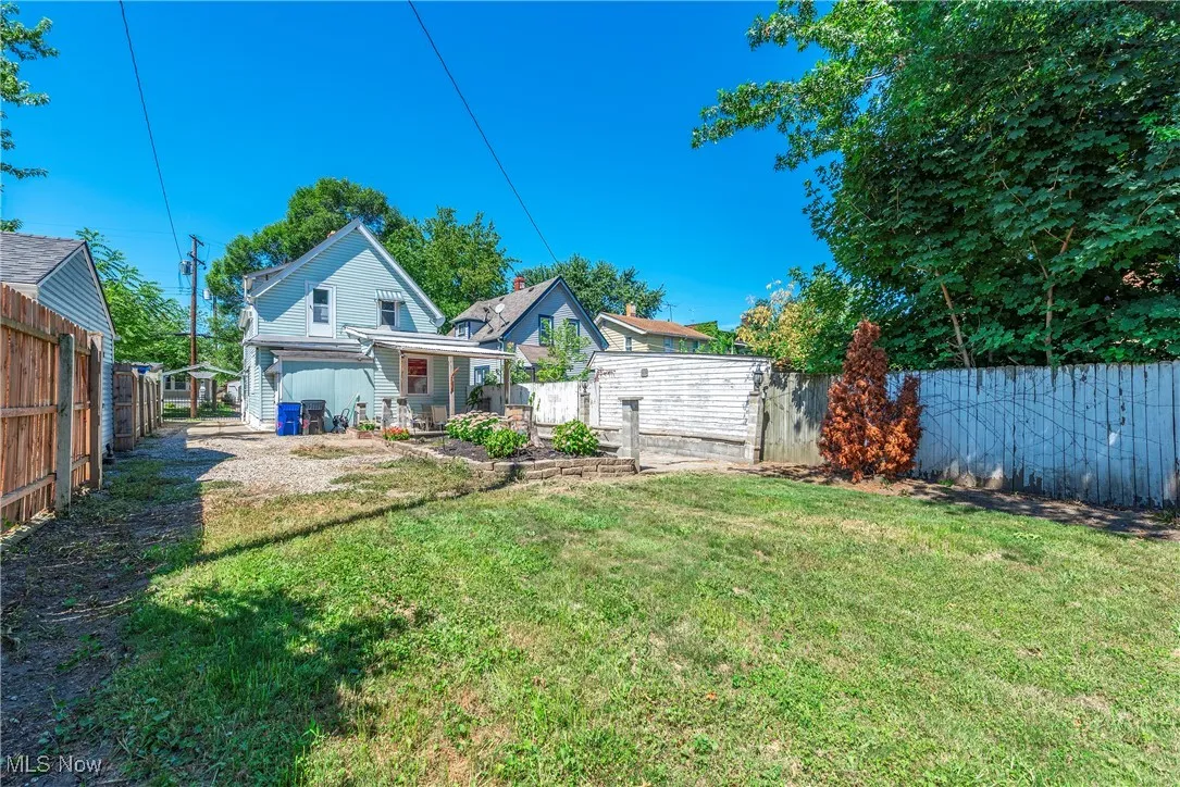 Back of house featuring a fenced backyard and a porch