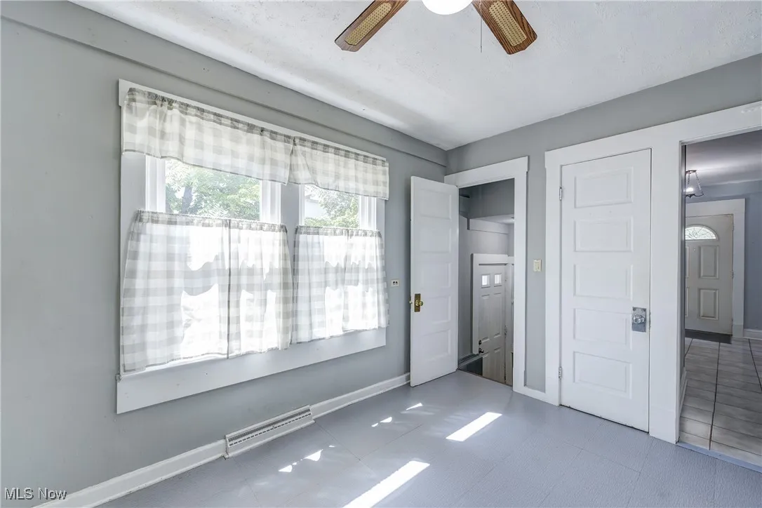 Unfurnished bedroom featuring a ceiling fan, a closet, and tile patterned flooring