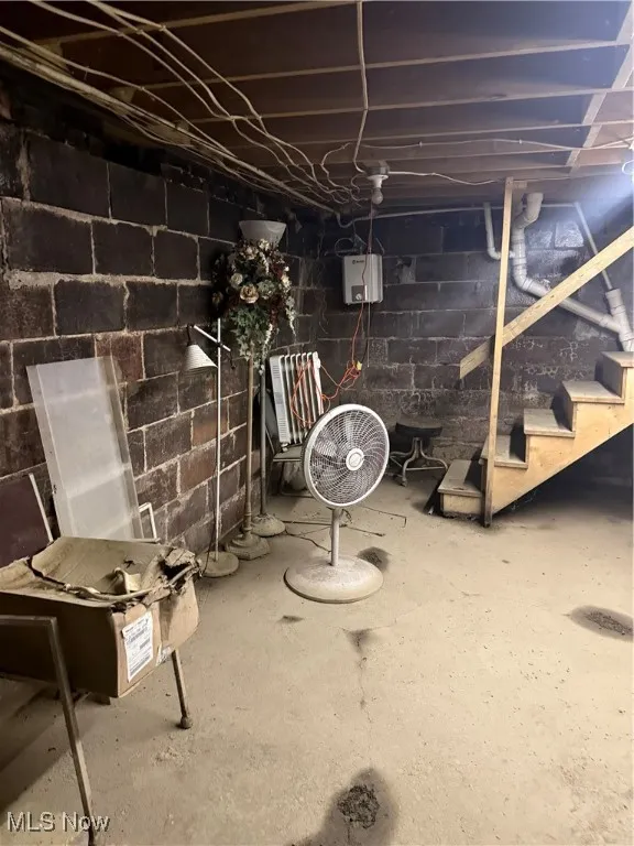Unfinished basement featuring stairs