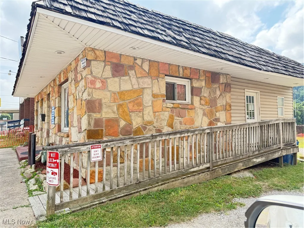 View of side of home featuring stone siding