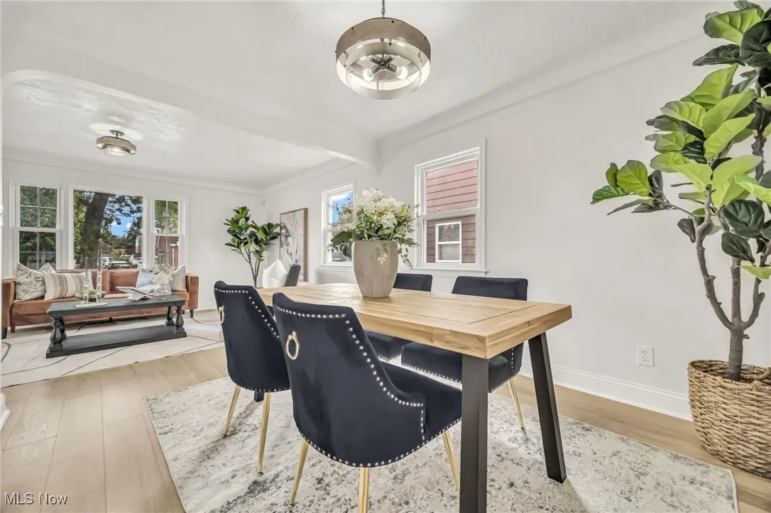 Dining space with light wood-style floors and baseboards