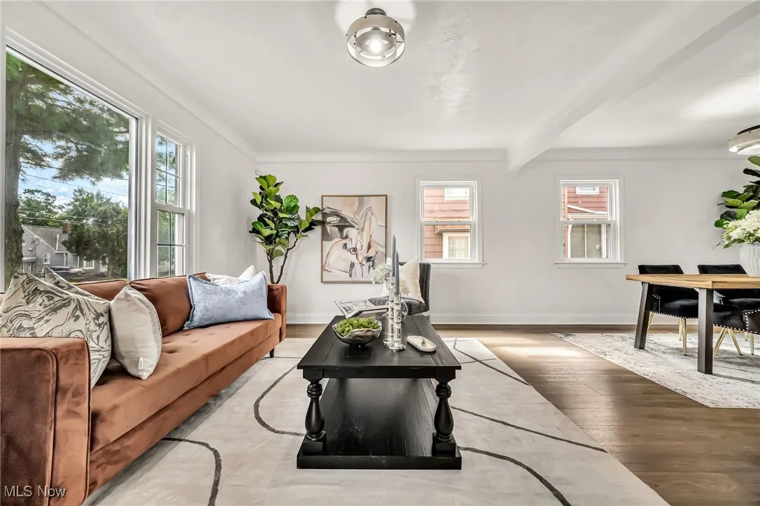 Living area featuring beamed ceiling and wood finished floors