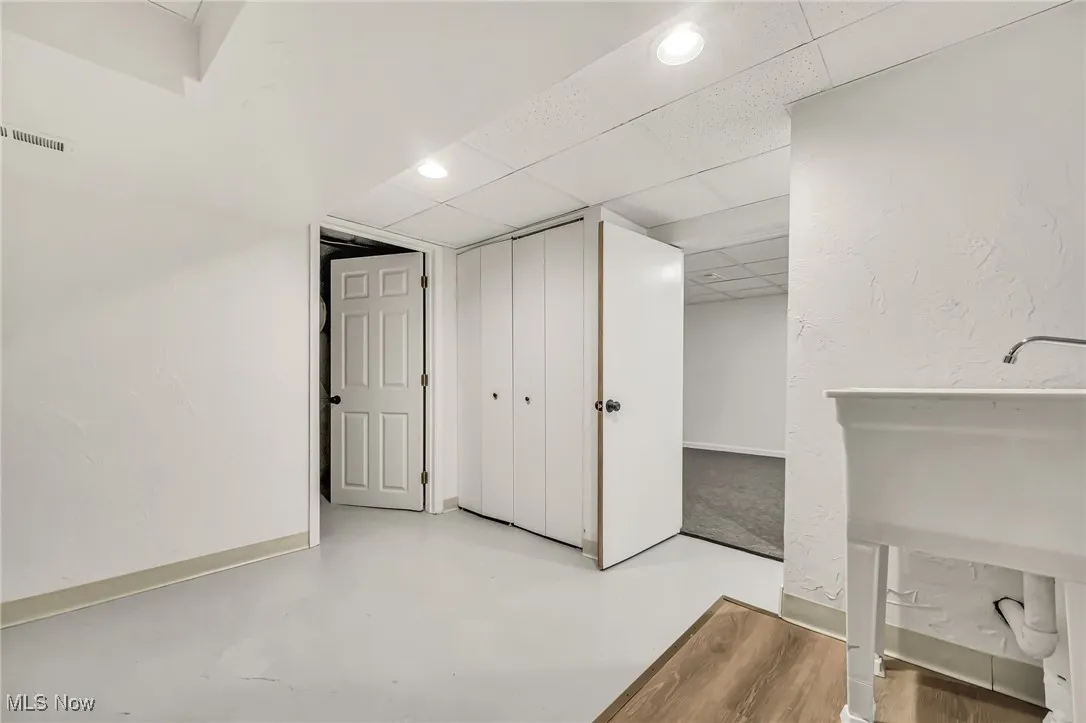 Finished below grade area with a paneled ceiling and recessed lighting