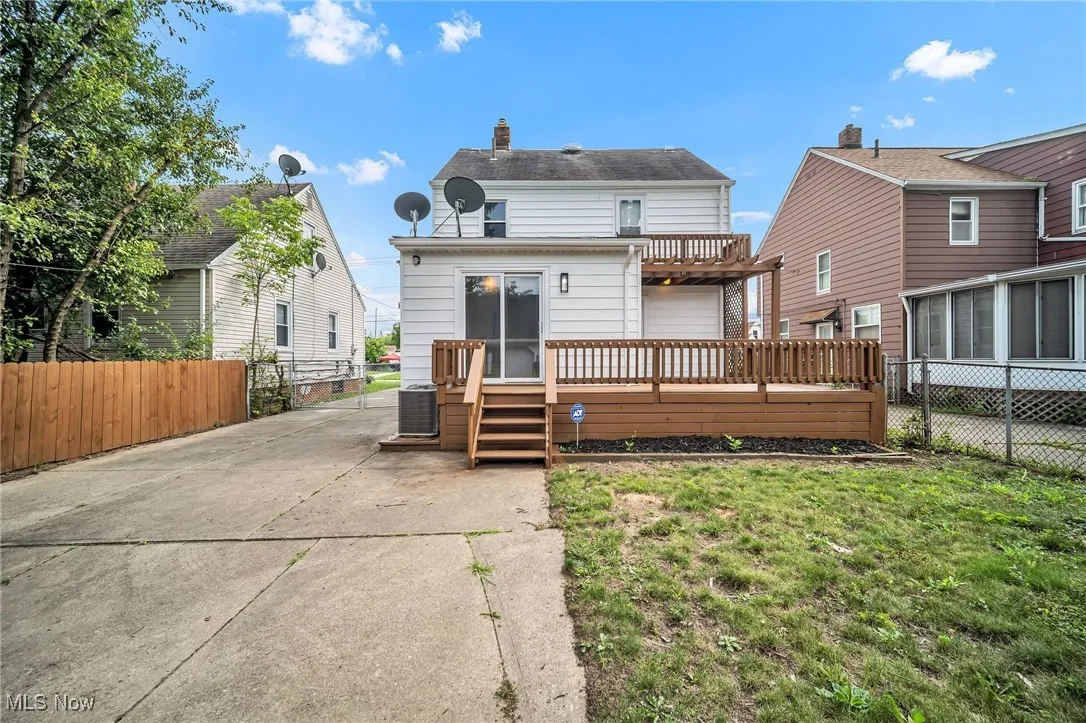 Back of property featuring a wooden deck and a chimney