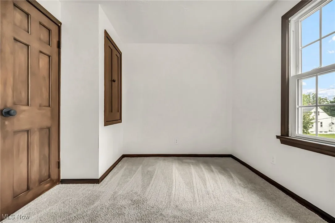 Unfurnished room with carpet and baseboards