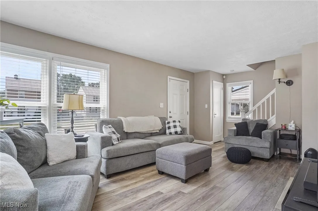 Living room featuring wood finished floors and stairs