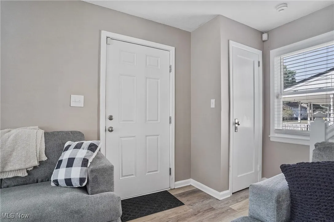 Entrance foyer featuring baseboards and light wood-style floors