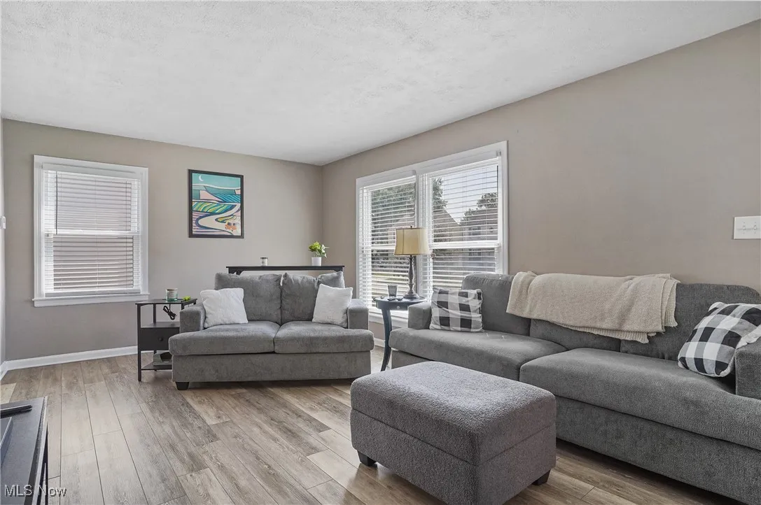 Living area featuring wood finished floors and a textured ceiling