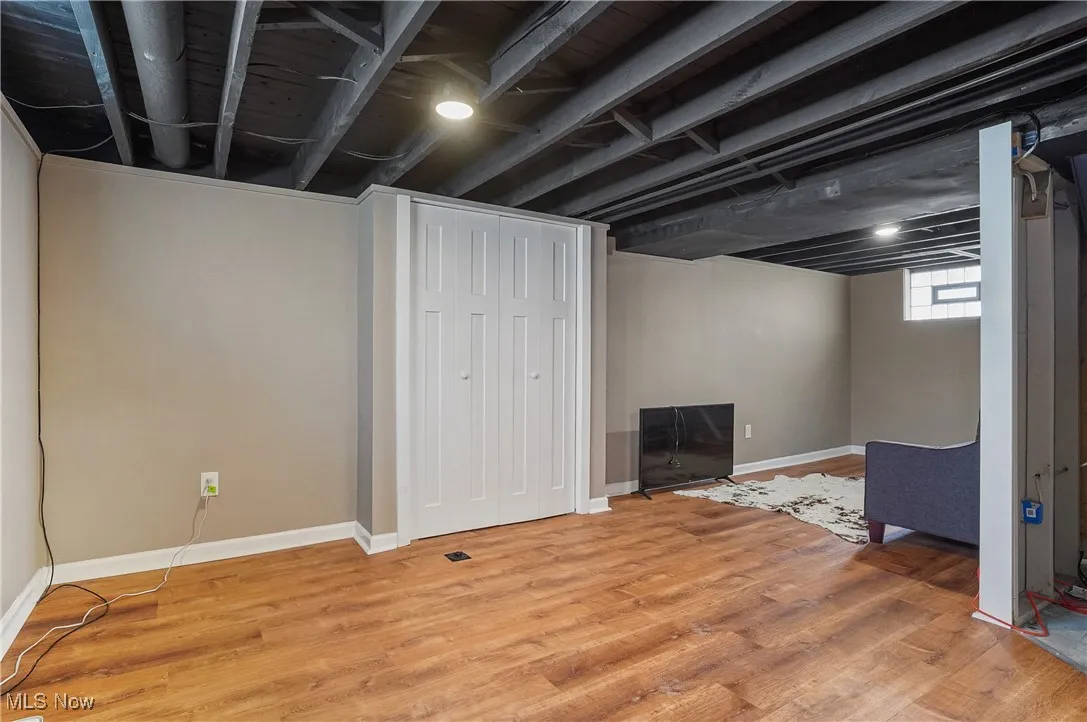 Below grade area with baseboards and light wood-type flooring
