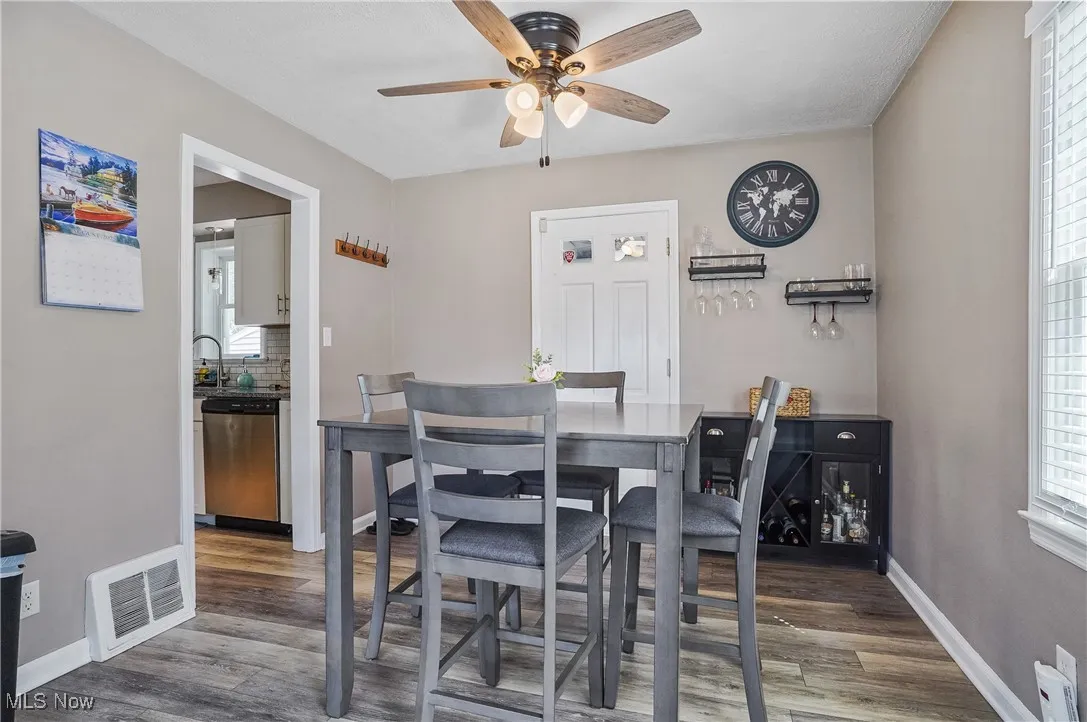 Dining area featuring light wood-style floors, plenty of natural light, and ceiling fan