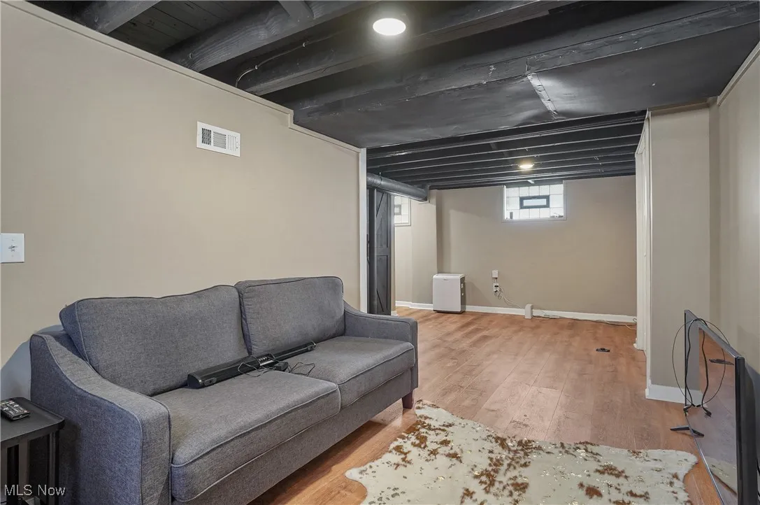 Living room with light wood-style floors and baseboards