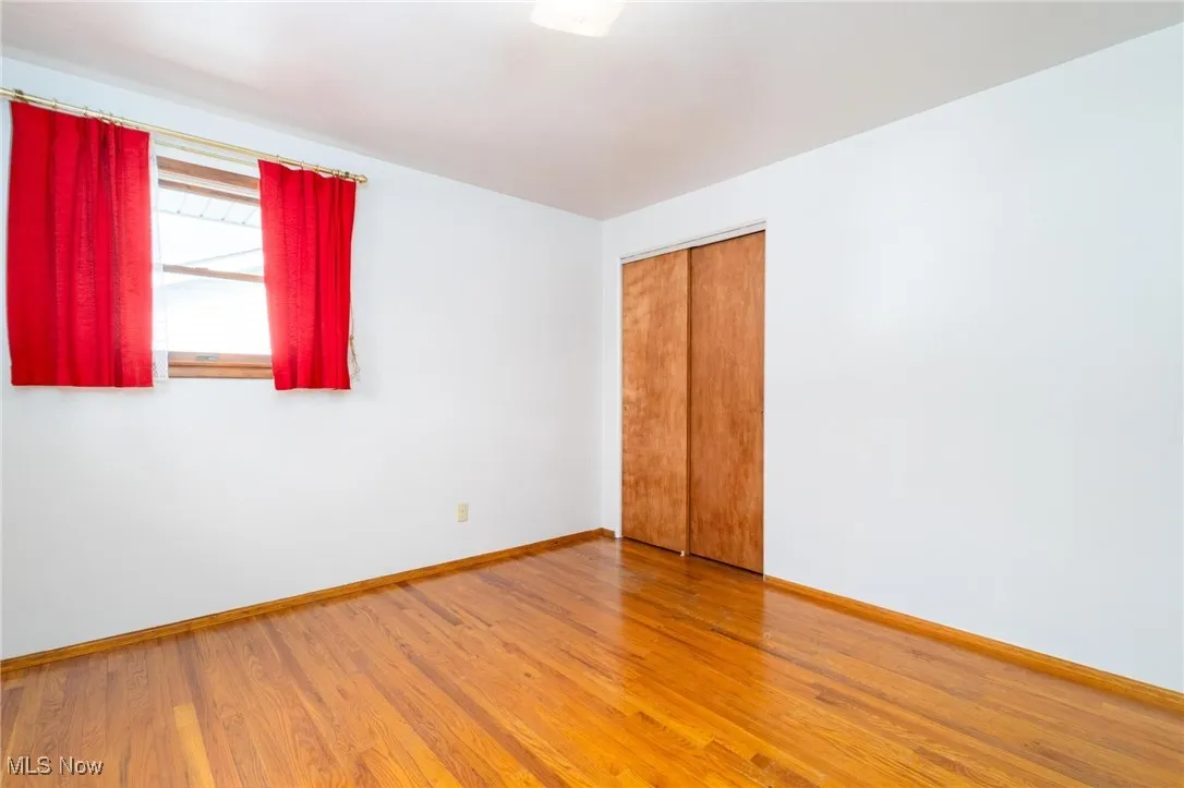 Spare room with wood finished floors and baseboards