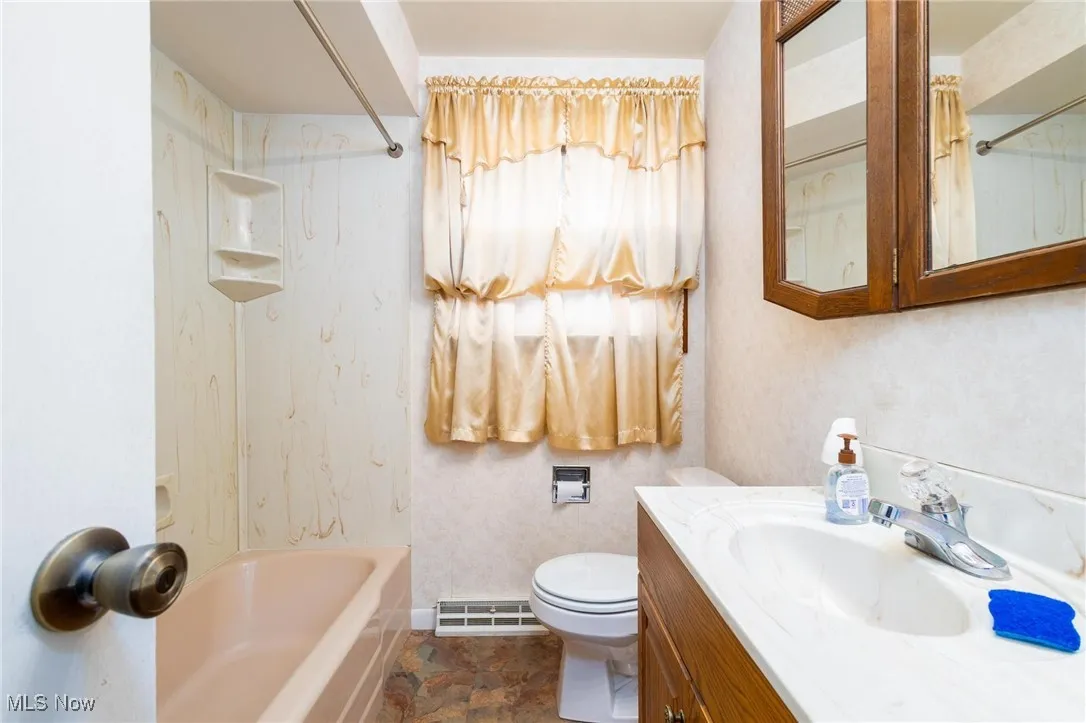Bathroom featuring shower / washtub combination and vanity