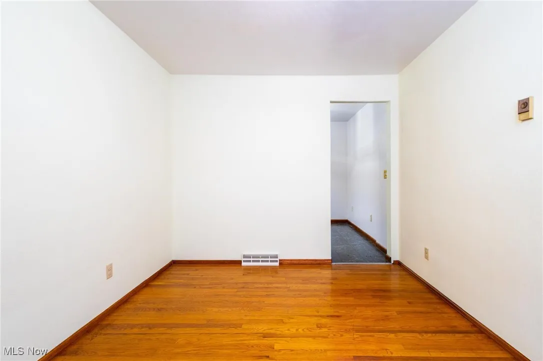 Unfurnished room featuring light wood-style floors and baseboards