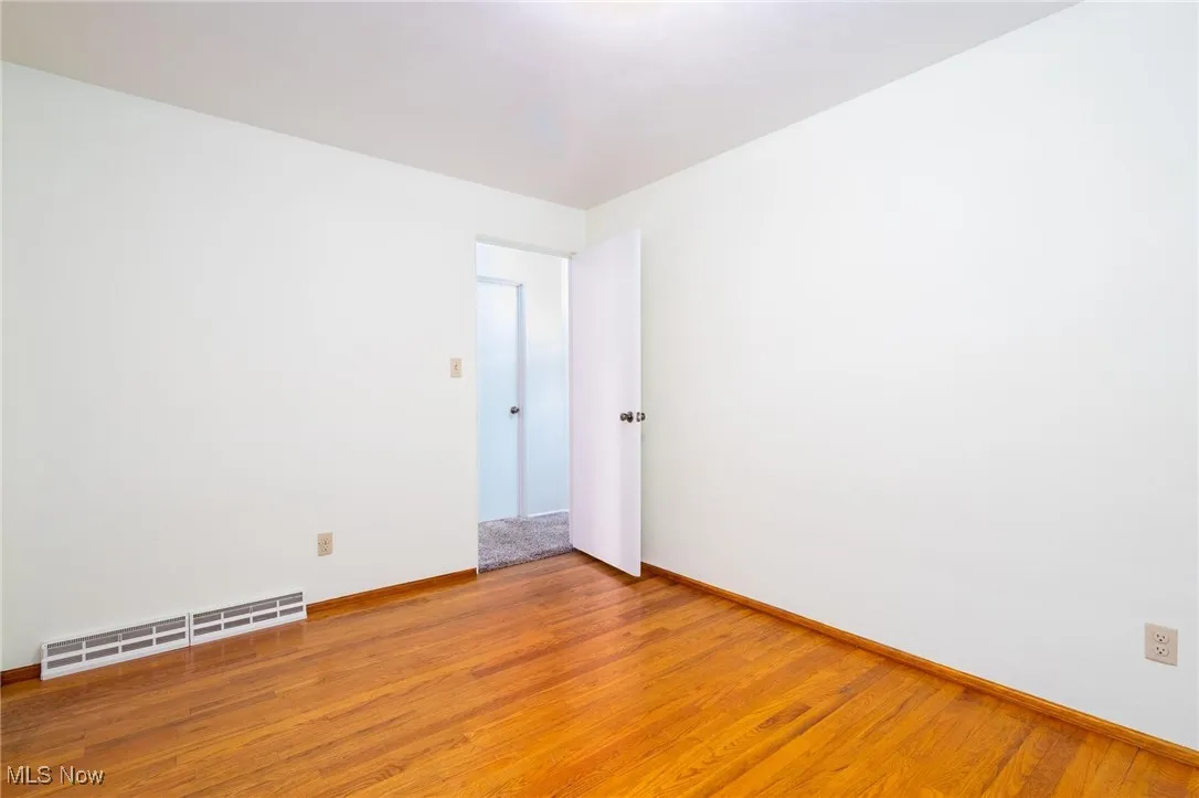Empty room featuring light wood-style flooring and baseboards