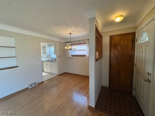 Entryway with a chandelier and wood finished floors