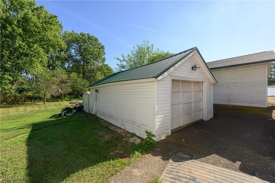 Detached garage with asphalt driveway