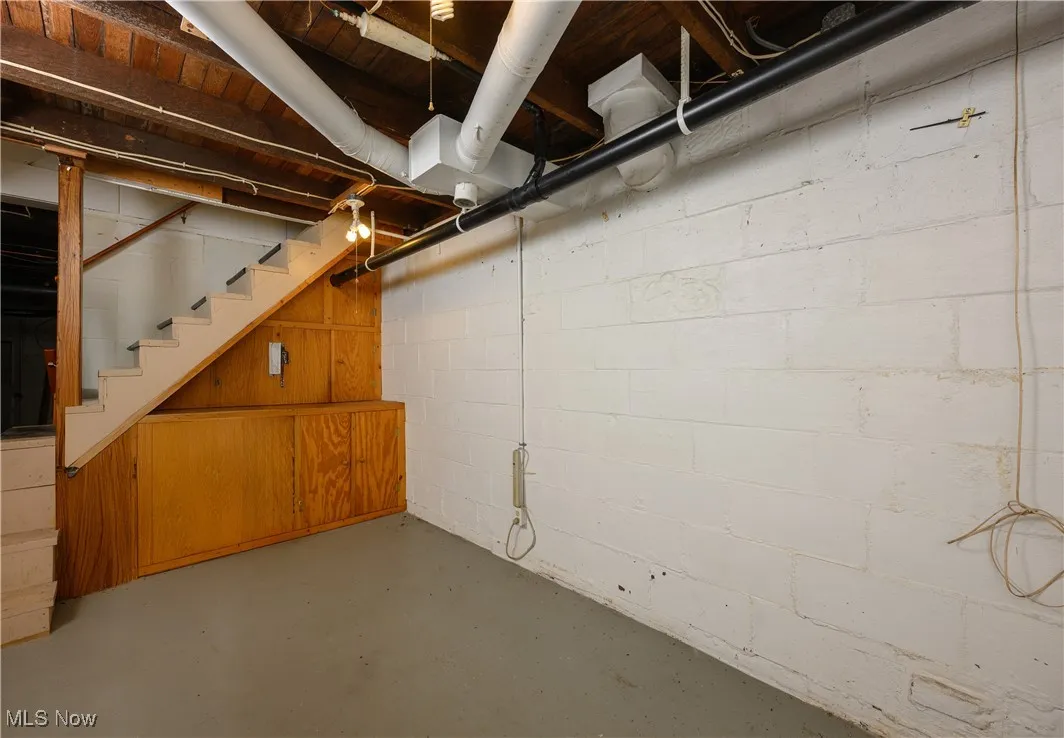 Unfinished basement featuring stairs
