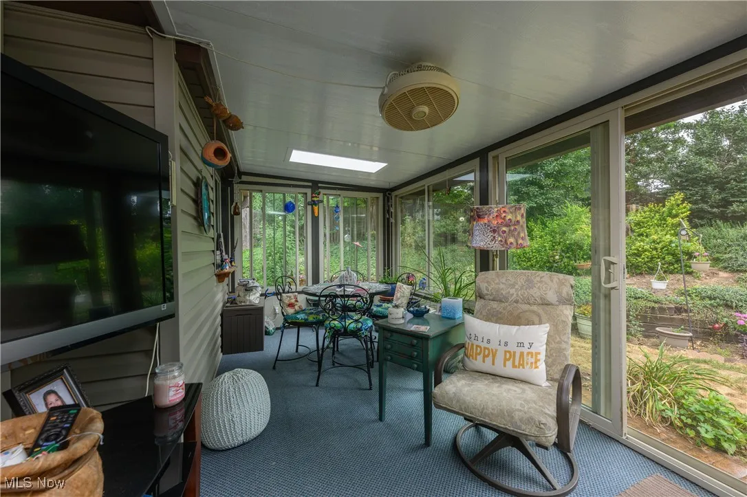 Sunroom featuring outdoor dining area