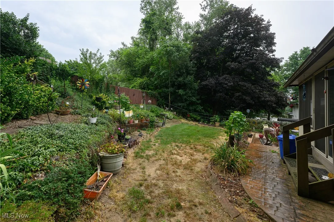 View of yard with a vegetable garden and view of scattered trees